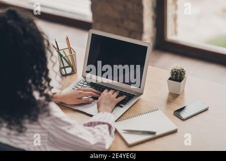 Photo portrait back rear spine view of woman working typing on laptop indoors Stock Photo