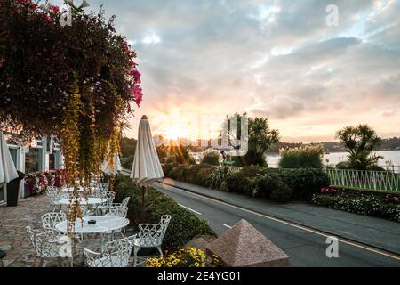 St Brelades Bay channel island of Jersey sunset sunrise dawn stunning vibrant orange sky beautiful seashore sand beach in morning evening hotel road Stock Photo