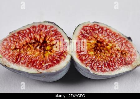 Half slices of ripe fig on a white background Stock Photo