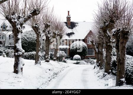 The pathway to All Saints Church, Leek Wootton, in snowy weather, Warwickshire, England, UK Stock Photo