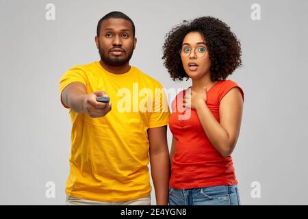 african american couple with tv remote control Stock Photo