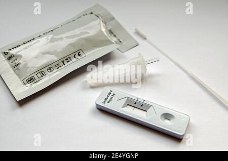 Basingstoke, UK - January 17, 2021: Angled view of the items from a used COVID-19 test kit showing a negative result. Stock Photo