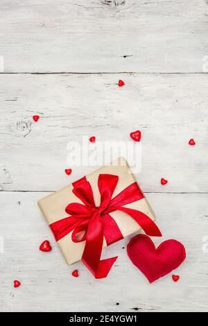 Valentine greeting card background with gift boxes, red ribbons and assorted hearts. Old white wooden boards background. Wedding or Birthday concept, Stock Photo