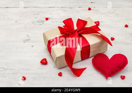 Valentine greeting card background with gift boxes, red ribbons and assorted hearts. Old white wooden boards background. Wedding or Birthday concept, Stock Photo