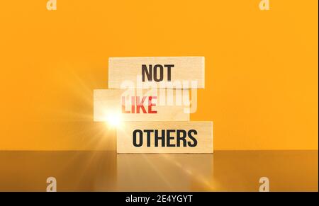Freelancer and startup conceptual inspiration business image, banner with wooden blocks and text inscription not like others Stock Photo