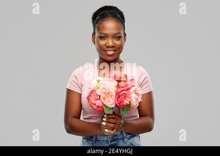 happy african american woman with bunch of flowers Stock Photo