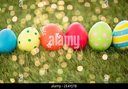 row of colored easter eggs on artificial grass Stock Photo