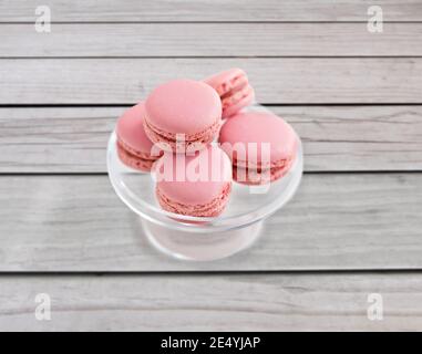 pink macaroons on glass confectionery stand Stock Photo