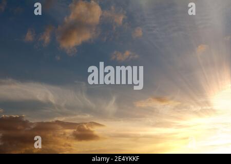 Stunning orange sunset background with dark blue skies and pretty clouds Stock Photo