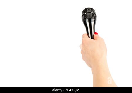 Modern microphone in woman hand isolated on a white background. Woman hand holding wireless microphone. Vocal microphone speaker concept. Stock Photo