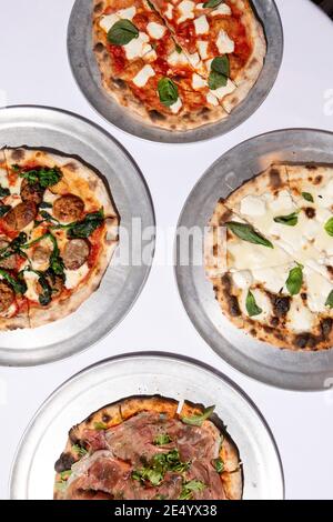 High Angle View of Four Brick Oven Pizzas Stock Photo