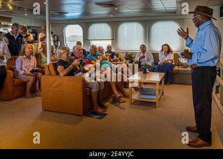 Raymond Masono, the Vice President and Minister of Mines of Bougainville in discussion with the passengers of an australian expedition ship. He informs True North passengers firsthand about the outcome of the referendum on independence Stock Photo