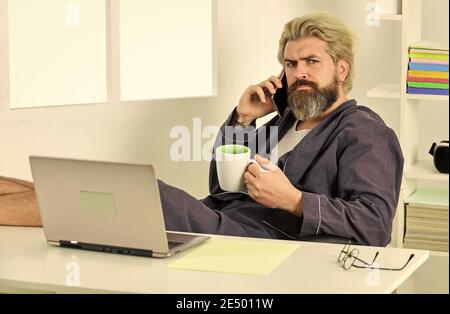 Sharing fresh ideas. relaxed businessman in home office. online agile business. man using laptop indoor. bearded man looking at his laptop screen. making business at home. e-commerce and shopping. Stock Photo