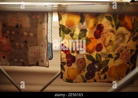 Folding clothes dryer with kitchen towels closeup. Stock Photo