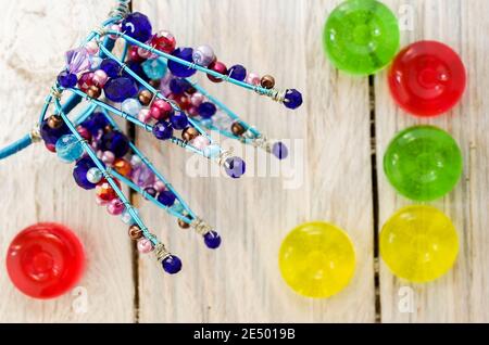 Crown made of wire and beads. Glass and iron. Multi-colored glasses and shapes. Top. Stock Photo