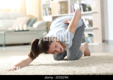 Mid Section of Toned Woman from Back Pain on Beach Stock Photo