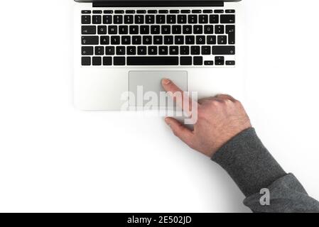 overhead view of person using touchpad or trackpad on laptop computer on white background Stock Photo
