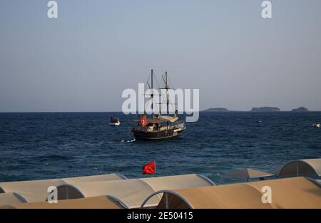 Large sailing ship in the Mediterranean sea in a pirate style in the open sea against a blue sky. The concept of summer holidays. Pirate cruise sail s Stock Photo