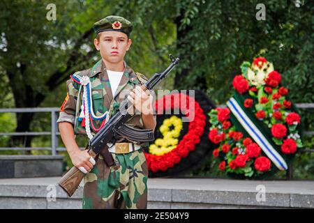 Russian boy in battledress posing with AK-47 Kalashnikov in the city Krasnojarsk, Krasnoyarsk Krai, Siberia, Russia Stock Photo