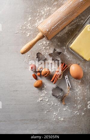 Ingredients for Baking Cookies with Flour, Egg, nuts, Butter and Rolling Pin, On Bright Grey Concrete Background. Top View Copy Space for text like re Stock Photo