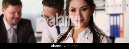 Pretty smiling lady posing in the office Stock Photo