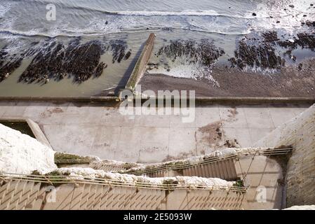 Staircase cut into the cliffside leading to the Undercliff Walk in Peacehaven, East Sussex Stock Photo