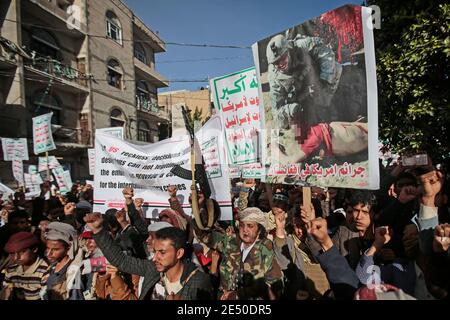 Sanaa, Yemen. 25th Jan, 2021. Houthi supporters chant slogans as they attend a rally against the United States over its decision to designate the Houthi rebels movement as a foreign terrorist organization. Credit: Hani Al-Ansi/dpa/Alamy Live News Stock Photo