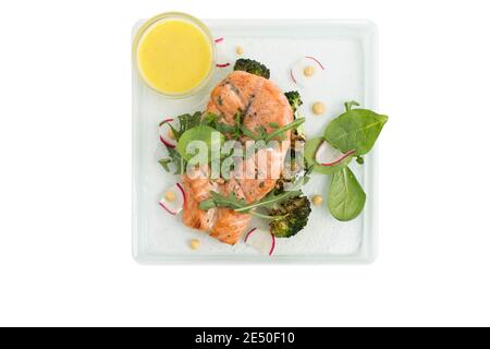 Fresh grilled salmon with yellow lemone sauce. Isolated in a white background. Close-up. Stock Photo