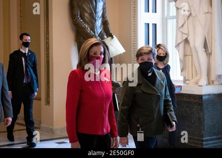 Speaker of the United States House of Representatives Nancy Pelosi (Democrat of California), left, walks with Chaplain of the House of Representatives Margaret Grun Kibben, right, from the House chamber to her office at the U.S. Capitol in Washington, DC, Monday, January 25, 2021. Credit: Rod Lamkey/CNP /MediaPunch Stock Photo