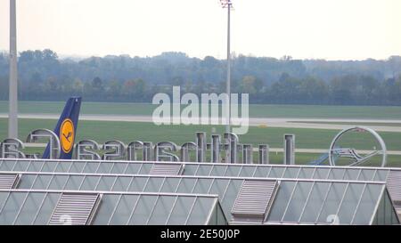 MUNICH, GERMANY - 11 OCTOBER 2015: View of the Munich Airport MUC terminal building with an airplane in background Stock Photo