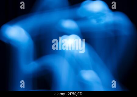 Long exposure blue lights abstract texture background. Colorful blue drawing patterns on black background. Stock Photo