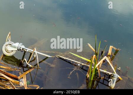 Supermarket trolley dumped in a local canal Stock Photo