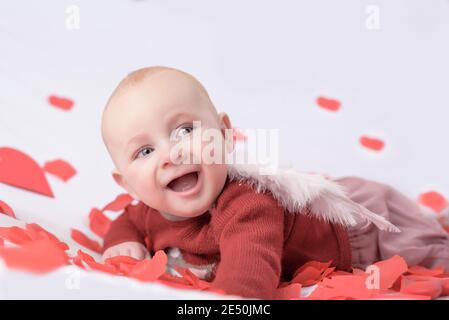 cute little baby with heart in hands. happiness and people concept - adorable baby. Valentine's Day Stock Photo