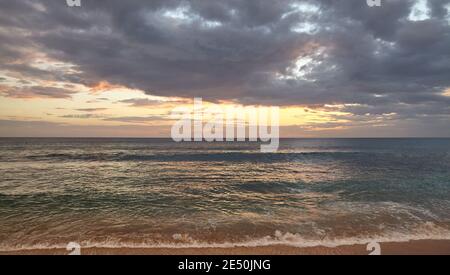 Seascape with dramatic cloudscape at sunset. Stock Photo