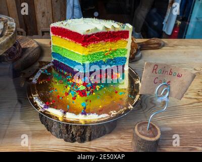 Rainbow Cake for sale in the window of a cafe bakery in London's Brick Lane. Stock Photo