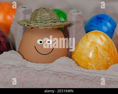 Egg with a funny face in the packaging Stock Photo
