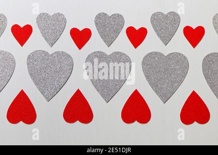 Red And Silver Hearts Pattern On Textured White Stock Photo