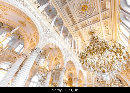 Wide angle view from below of a white and gold ball room in the Ermitage museum, lit by large chandeliers Stock Photo