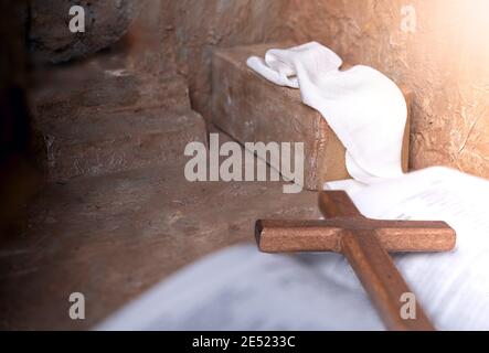 Empty Tomb and close door with Wooden cross over open bible background with copy space for inscription. Christian Easter concept. Stock Photo