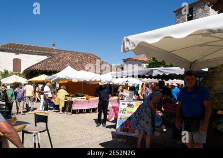 PUJOLS, FRANCE - JULY 14th, 2019 : a typical French market on the village square on a summer morning in one of France 'Most beautiful village' Stock Photo
