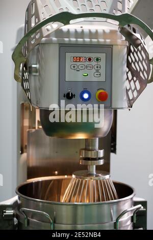 Industrial wheat flour kneader machine.  Professional planetary bread dough mixer. Stock Photo