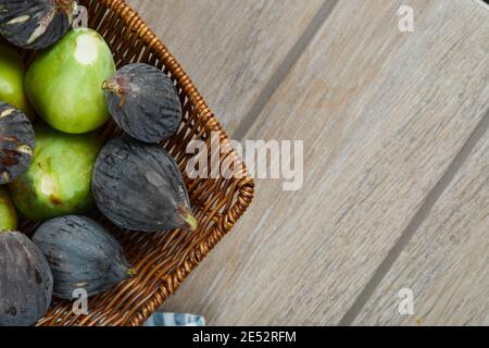 Top view of green and black figs in a basket Stock Photo