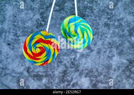 Two colorful lollipops on marble background Stock Photo