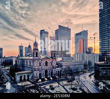 Beautiful panoramic aerial drone view on All Saints Church - Roman Catholic church located at Grzybowski Square, Warsaw City Skyscrapers, PKiN, and Va Stock Photo