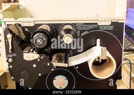Sticker label printer. Barcode digital printer and applicator machine. Stock Photo