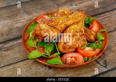 Buffalo chicken with salad on wooden table. Close up. Stock Photo