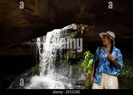 Thai travelers women people travel visit and playing water take photo at Tham Buang Waterfall in jungle on Phu Foi Lom in Pa Phan Don National Forest Stock Photo