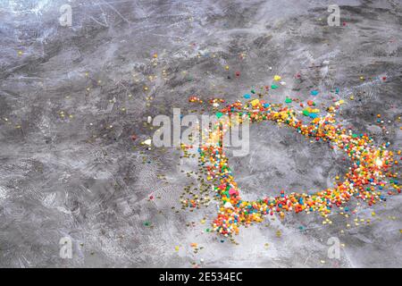 Heart shape made from small colorful candies on a white marble background. Valentine day. About love. High quality photo Stock Photo