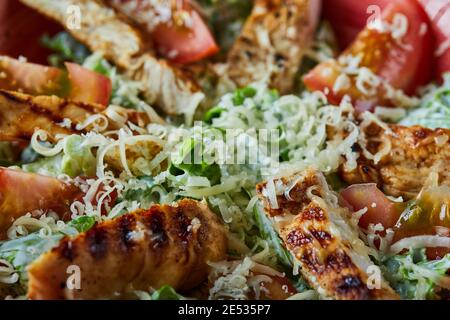 Salad with slice of chicken with cheese and tomatoes Stock Photo