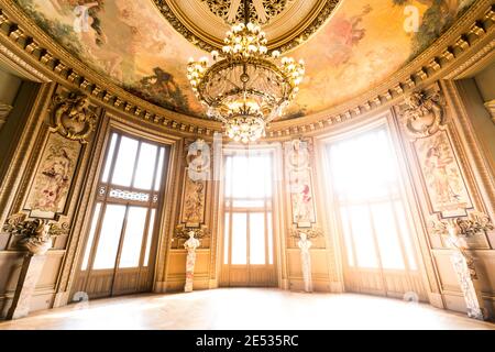 Wide angle view of a a richly adorned ballroom flooded in light in the Opera building Stock Photo